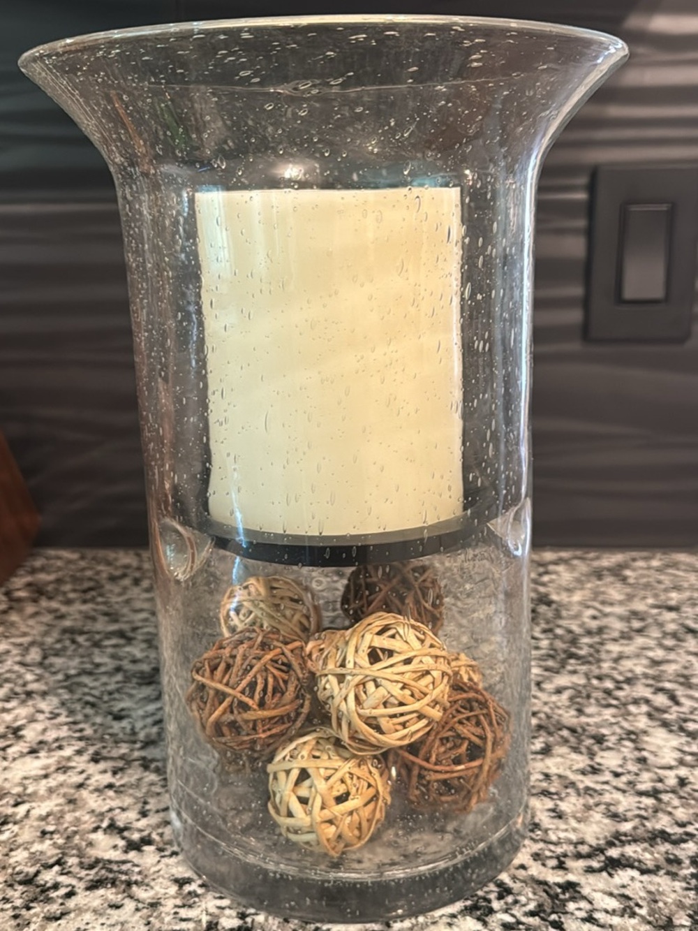 Clear Glass Hurricane Vase with Ivory Candle and Decorative Rattan Balls
